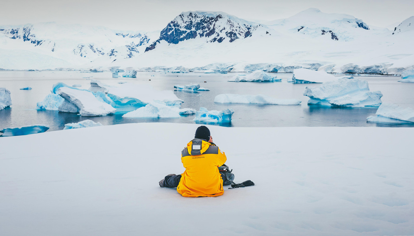 Passenger sitting on Antarctic Landscape