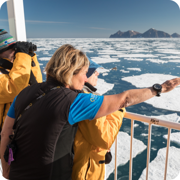 Passengers looking at the landscape on the ship deck