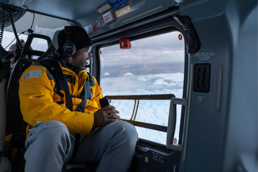 Close-up of guest flightseeing on helicopter in the Antarctic. Photo by Michelle Sole. 