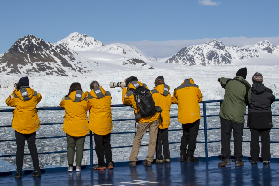 Guests onboard ship photographing Svalbard landscape. Photo by Cindy Miller Hopkins.