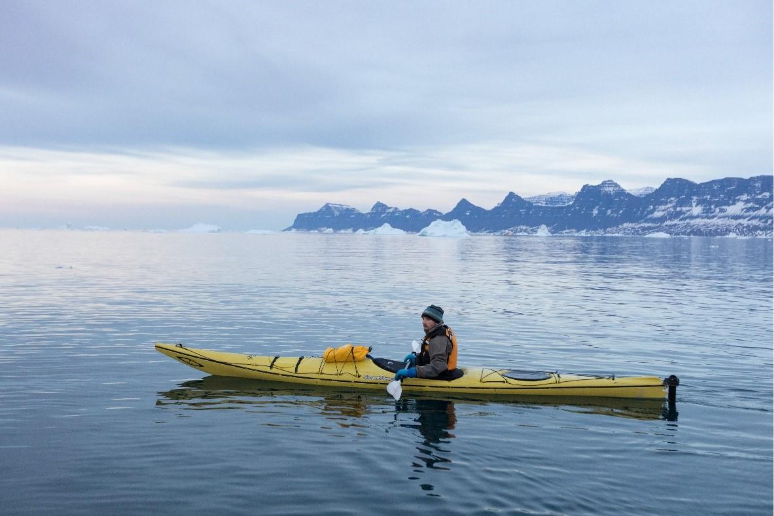 Quark expeditions’ guest kayaking in open sea water of Greenland. 